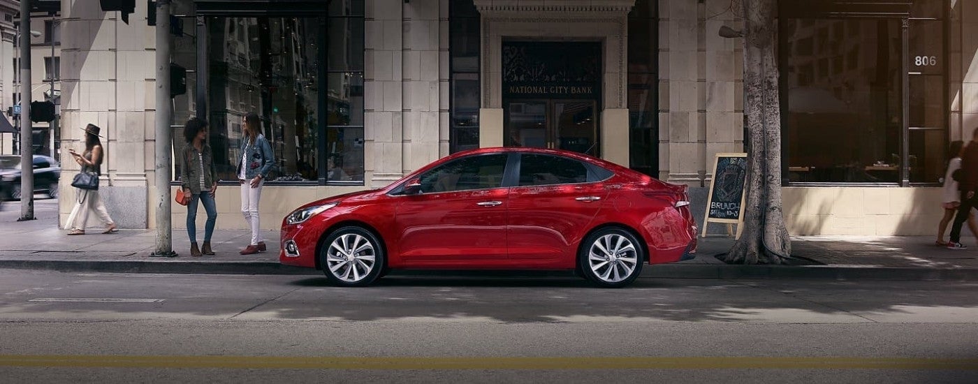 A red 2020 Hyundai Accent shown parked outside of a restaurant.