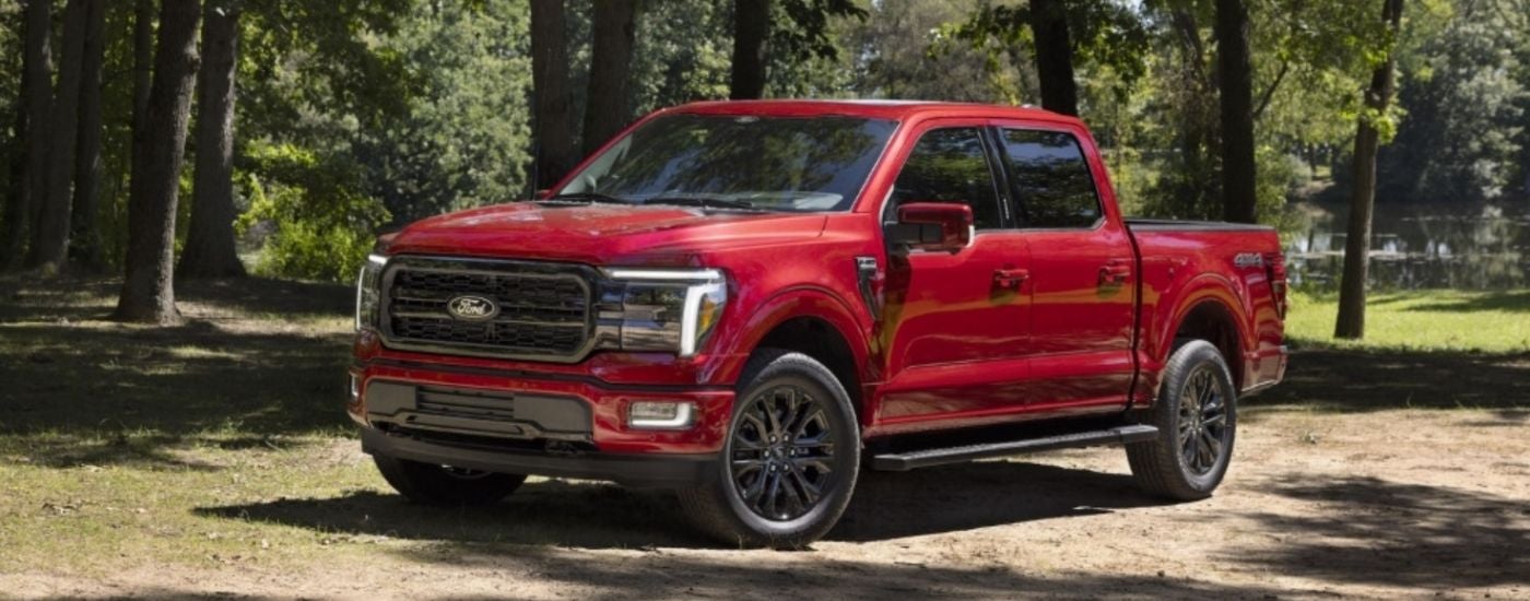 A red 2024 Ford F-150 is shown parked off-road.