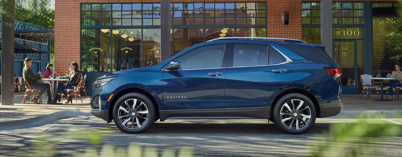 Blue 2022 Chevy Equinox parked outside of a cafe.