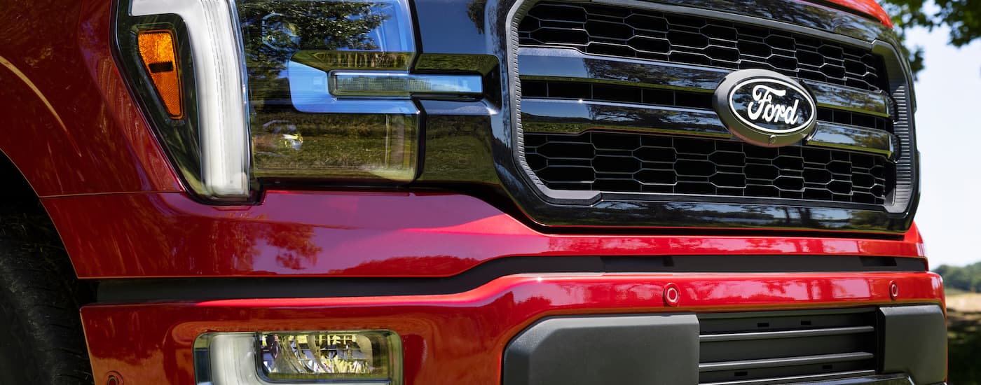 Grille and headlight on a red 2024 Ford F-150 Lariat