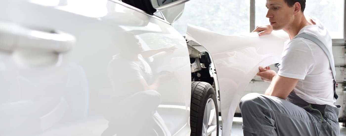 Side of a white vehicle at an auto body shop