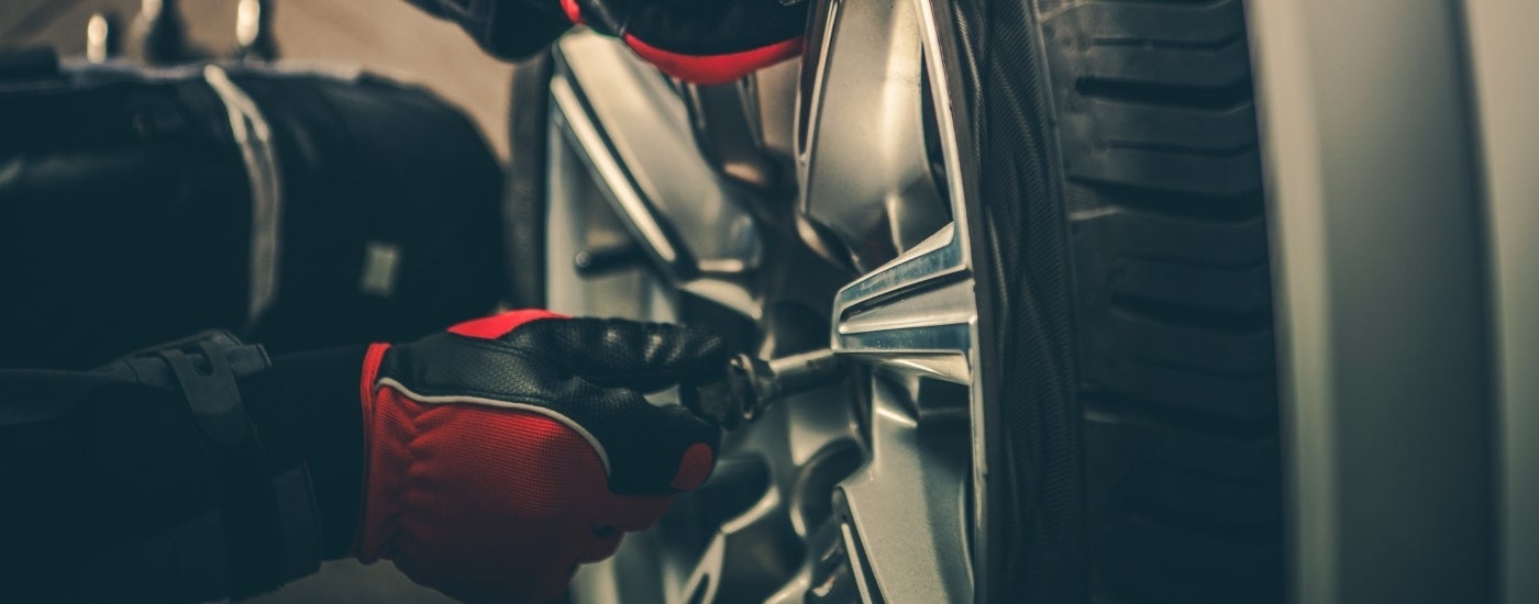 Close-up of a mechanic installing a wheel at a service center