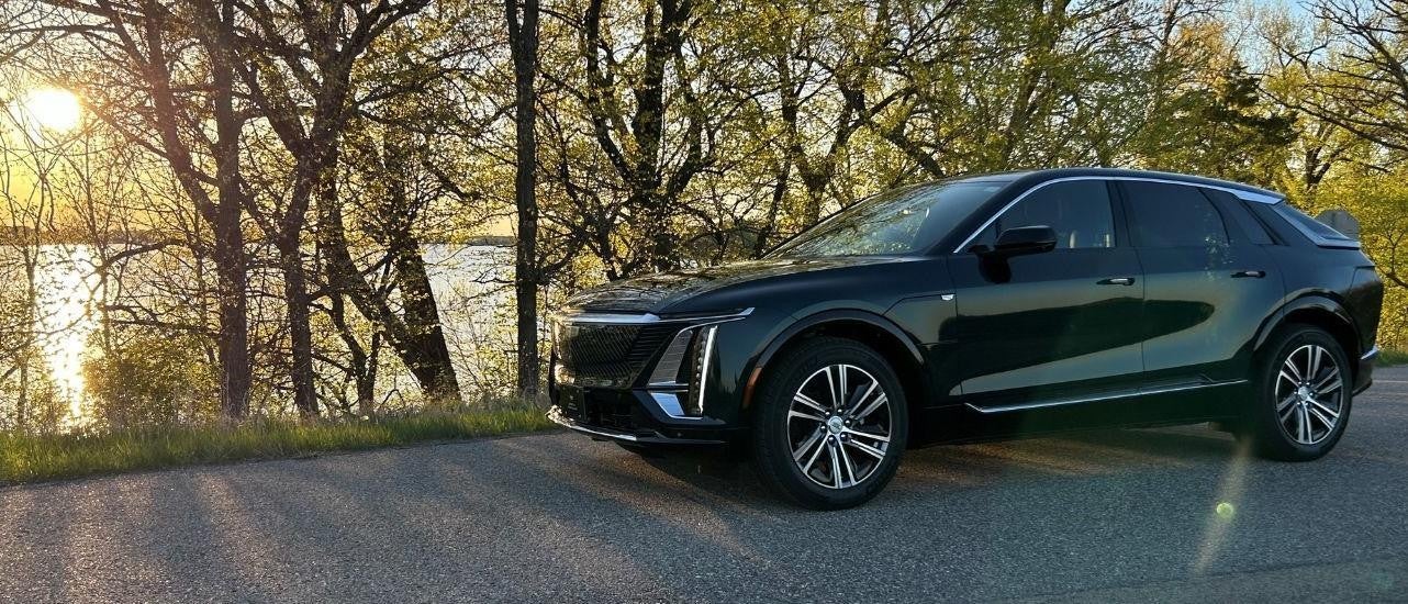 Black 2024 Cadillac LYRIQ parked near a pond