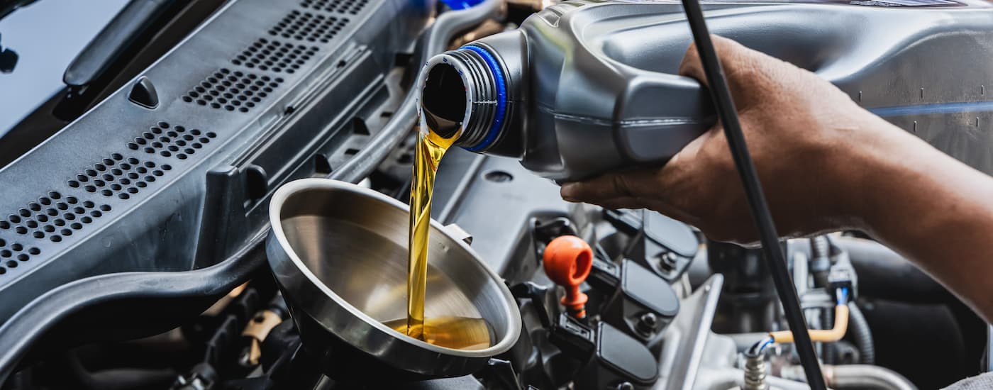 Oil can being poured into a funnel.